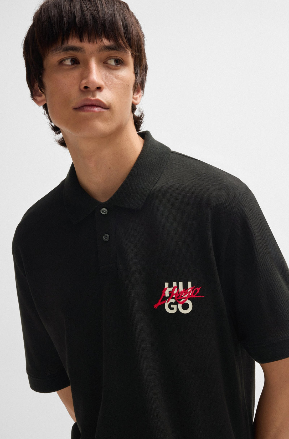 Close-up of the logo graphic on the HUGO Dalogpolo Polo Shirt in Black, emphasizing its striking branding detail.