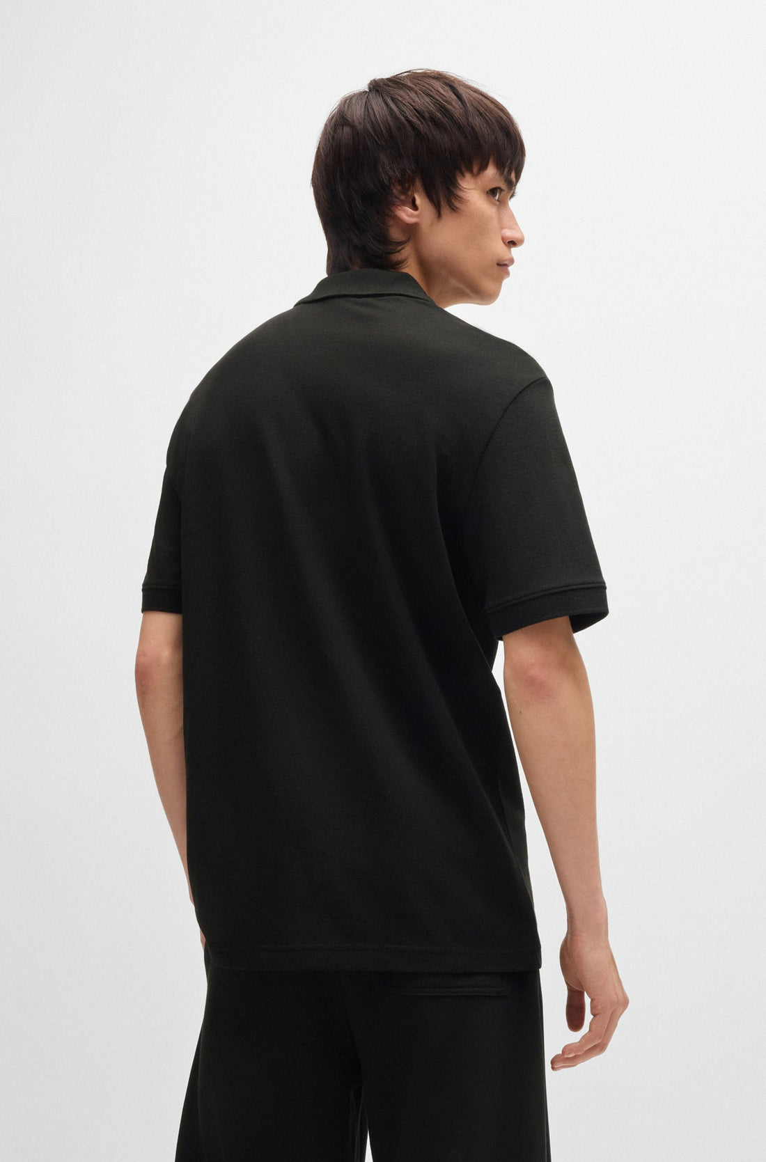 Back view of the HUGO Dalogpolo Logo Graphic Polo Shirt in Black, showcasing its clean, streamlined design.