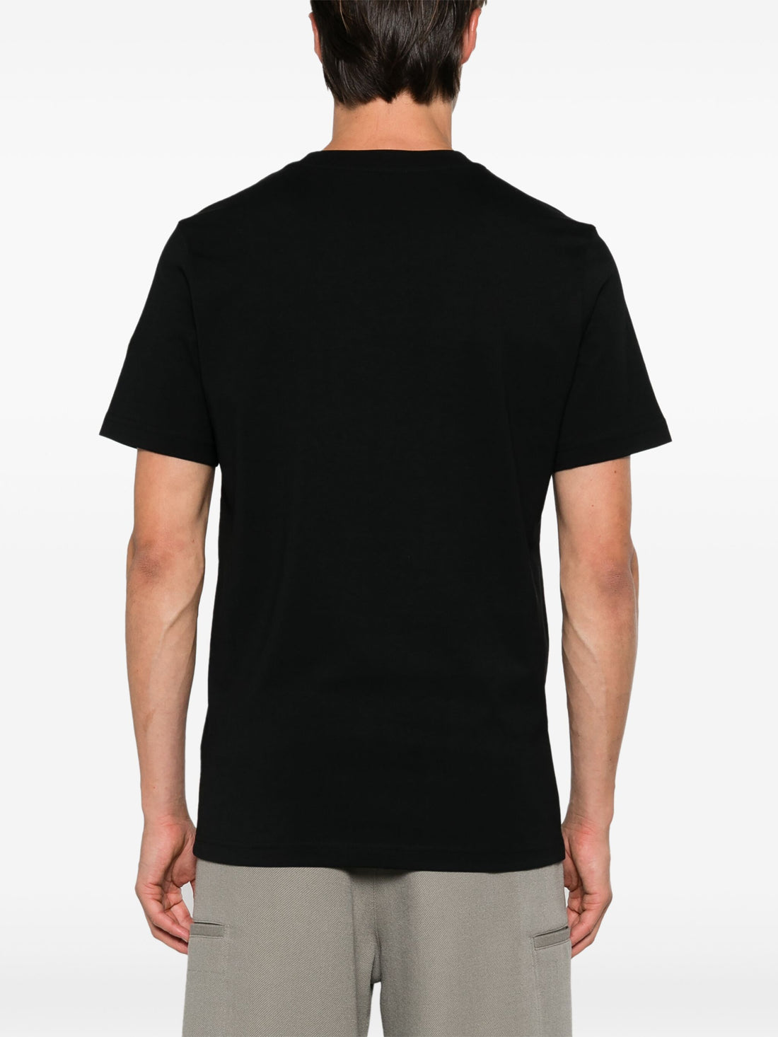 Back view of the MONCLER Logo Print Cotton T-Shirt in Black, showcasing its clean and minimal rear design.