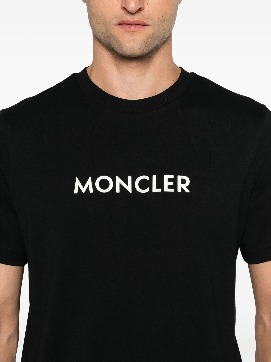 Close-up of the printed MONCLER logo on the Cotton T-Shirt in Black, emphasizing its striking branding detail