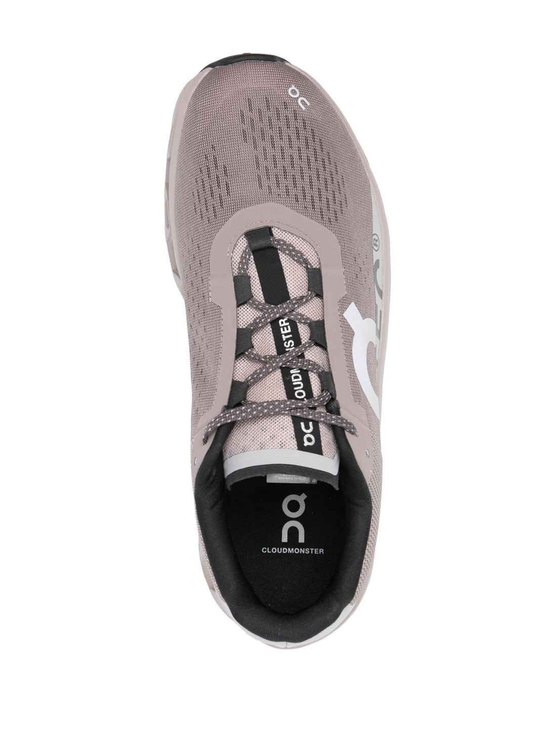 Top view of On Running Cloudmonster running sneakers in taupe grey showcasing lace-up design.