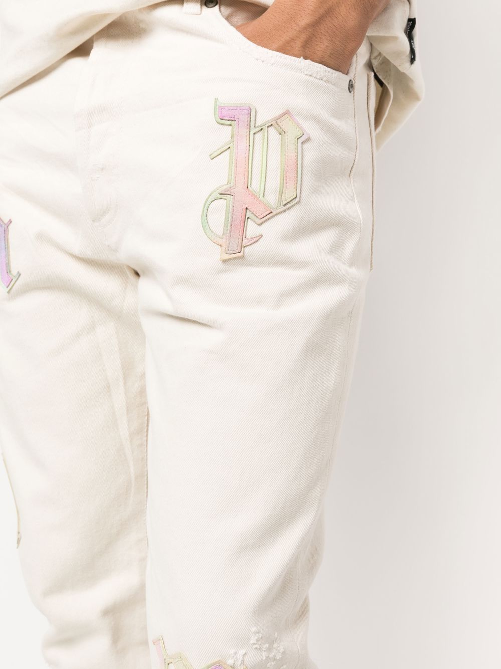 PALM ANGELS Bull Rainbow Logo Patch Reg 5 Pocket Jeans Off White - MAISONDEFASHION.COM